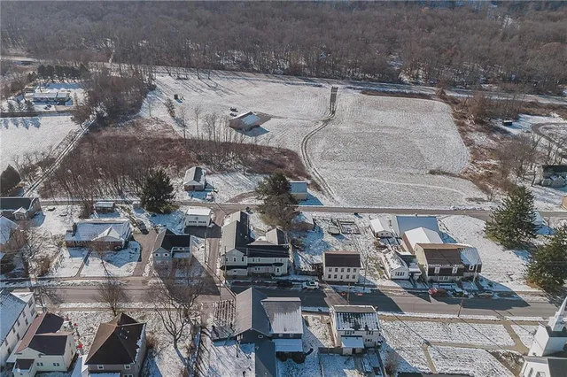an aerial view of a house with outdoor space