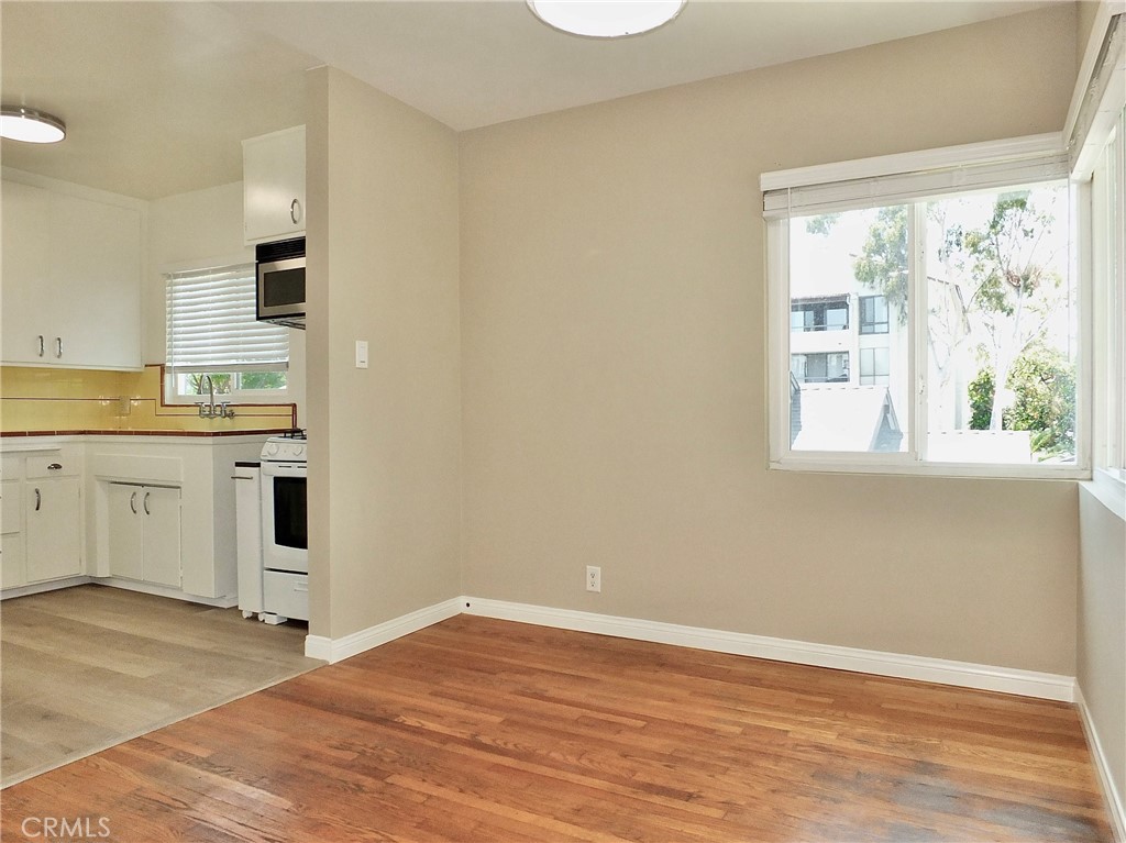 1808 East Appleton Street, Unit 7 Long Beach, CA 90802 - Photo 17 of 44 a view of a kitchen with wooden floor and windows