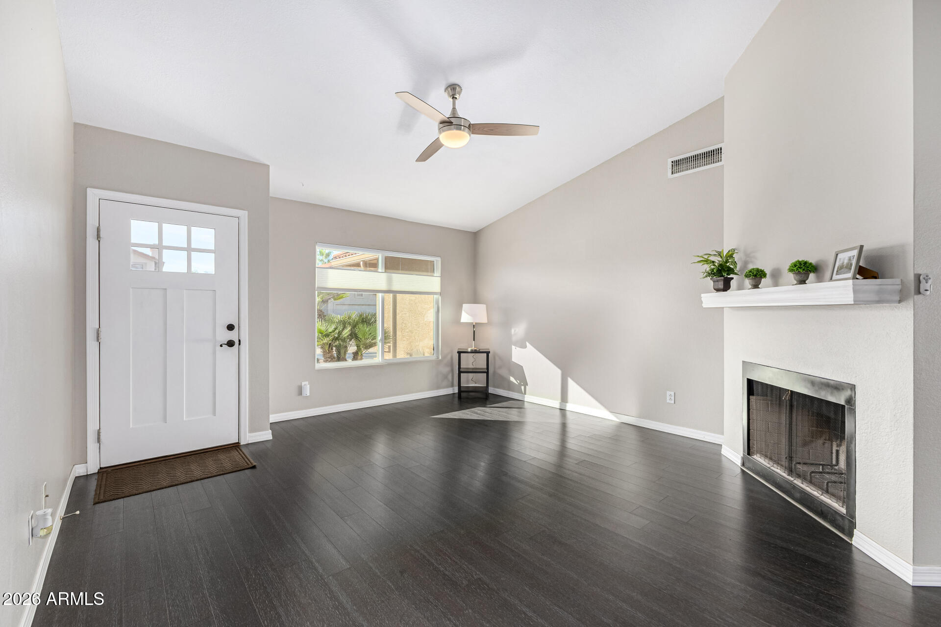 2710 East Rock Wren Road Phoenix, AZ 85048 - Photo 8 of 56 a view of an empty room with wooden floor and a window