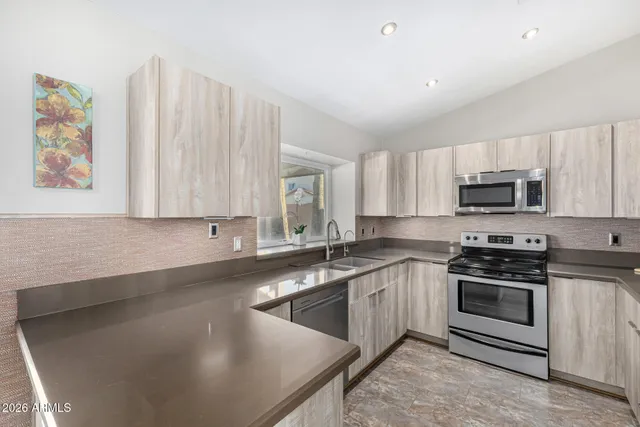 a kitchen with granite countertop a sink and a window