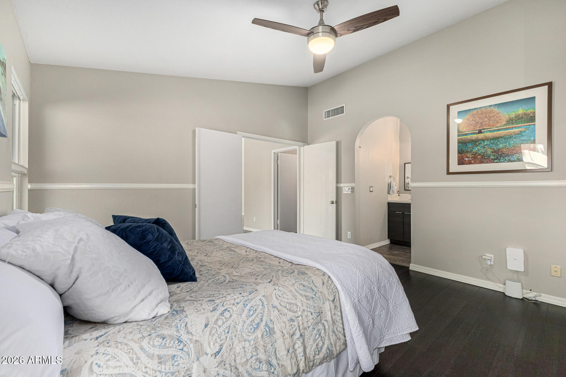 2710 East Rock Wren Road Phoenix, AZ 85048 - Photo 17 of 56 a bedroom with a bed and a painting on the wall