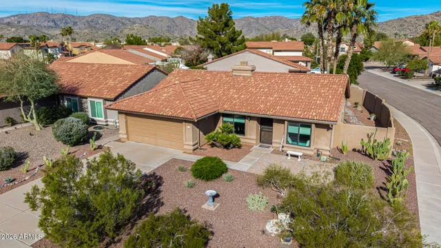 an aerial view of a house with garden space and street view