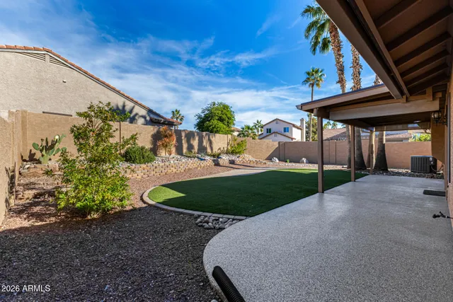 a refrigerator with white cabinets and wooden floor