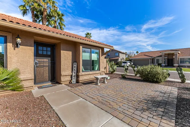 a view of a house with backyard porch and sitting area