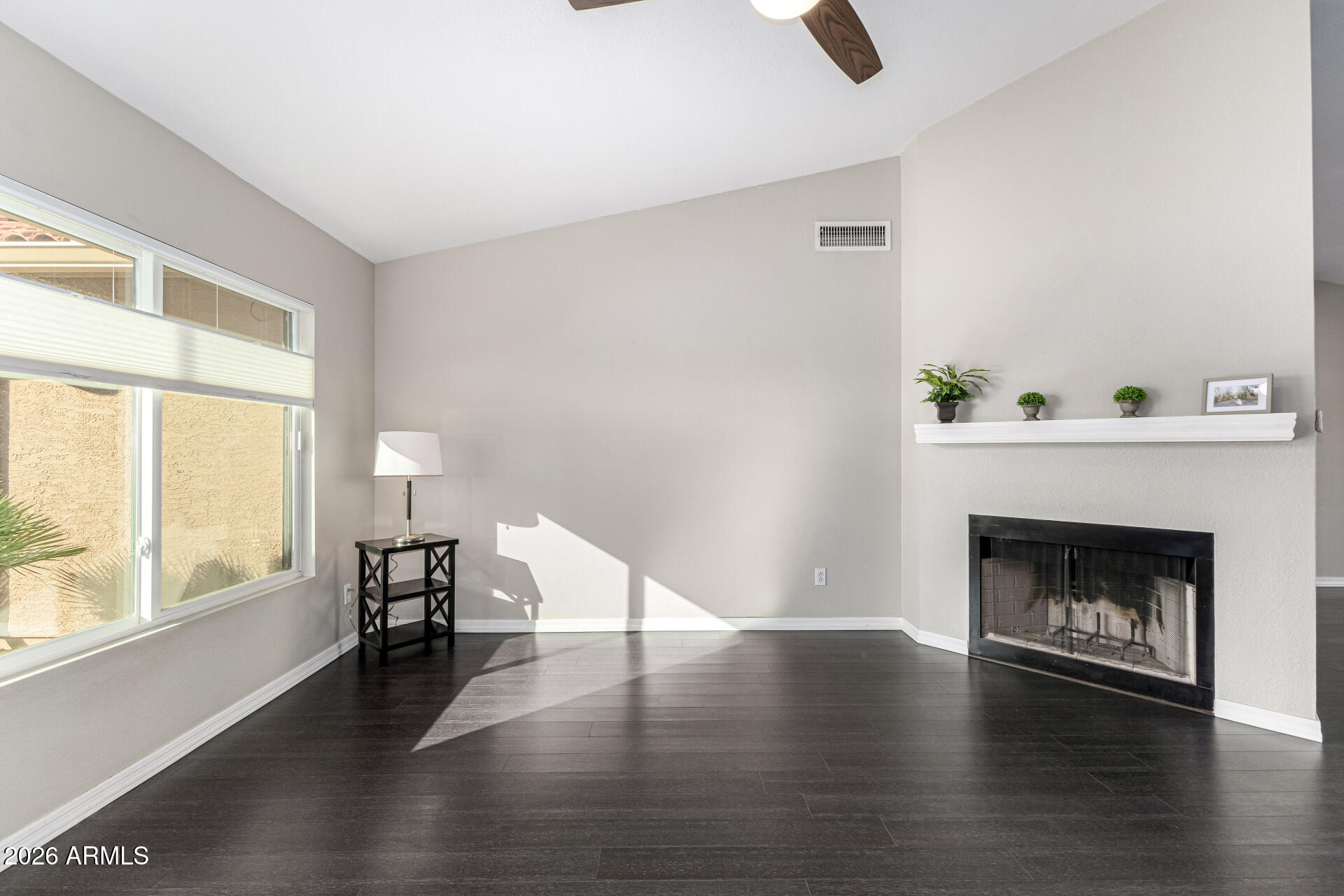 2710 East Rock Wren Road Phoenix, AZ 85048 - Photo 5 of 56 a view of an empty room with window and wooden floor