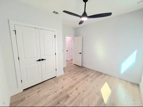 a view of a room with wooden floor