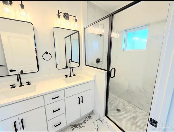 a bathroom with double vanity sink and mirror