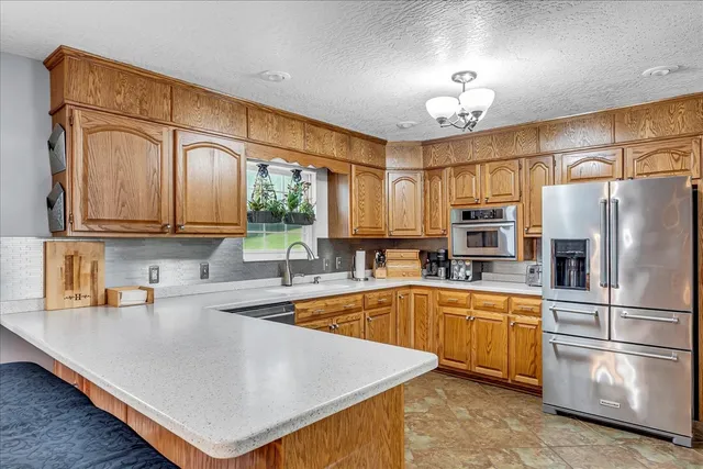 a kitchen with stainless steel appliances granite countertop a sink and cabinets