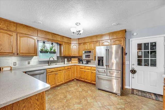 a kitchen with stainless steel appliances granite countertop a sink and cabinets