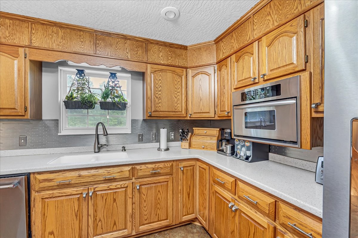 3955 River Road Baxter, TN 38544 - Photo 17 of 78 a kitchen with stainless steel appliances granite countertop a sink and cabinets