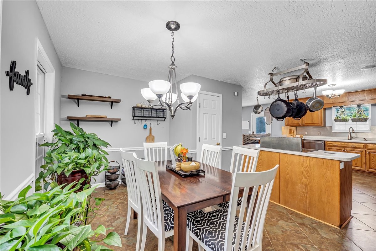 3955 River Road Baxter, TN 38544 - Photo 23 of 78 a dining room filled chandelier and kitchen view