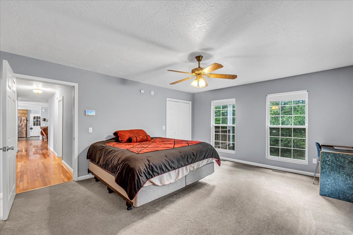 3955 River Road Baxter, TN 38544 - Photo 27 of 78 a bedroom with a bed and a chandelier