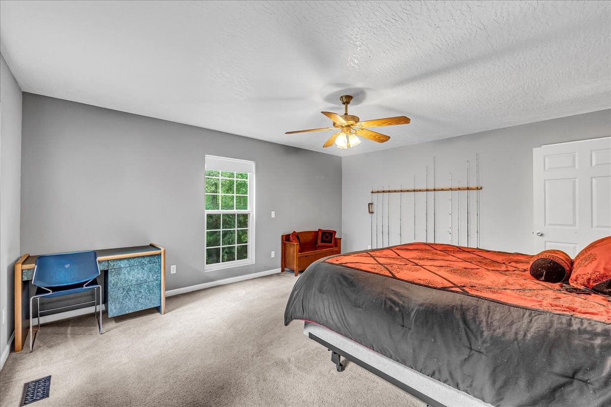 3955 River Road Baxter, TN 38544 - Photo 28 of 78 a bed sitting in a bedroom next to a window