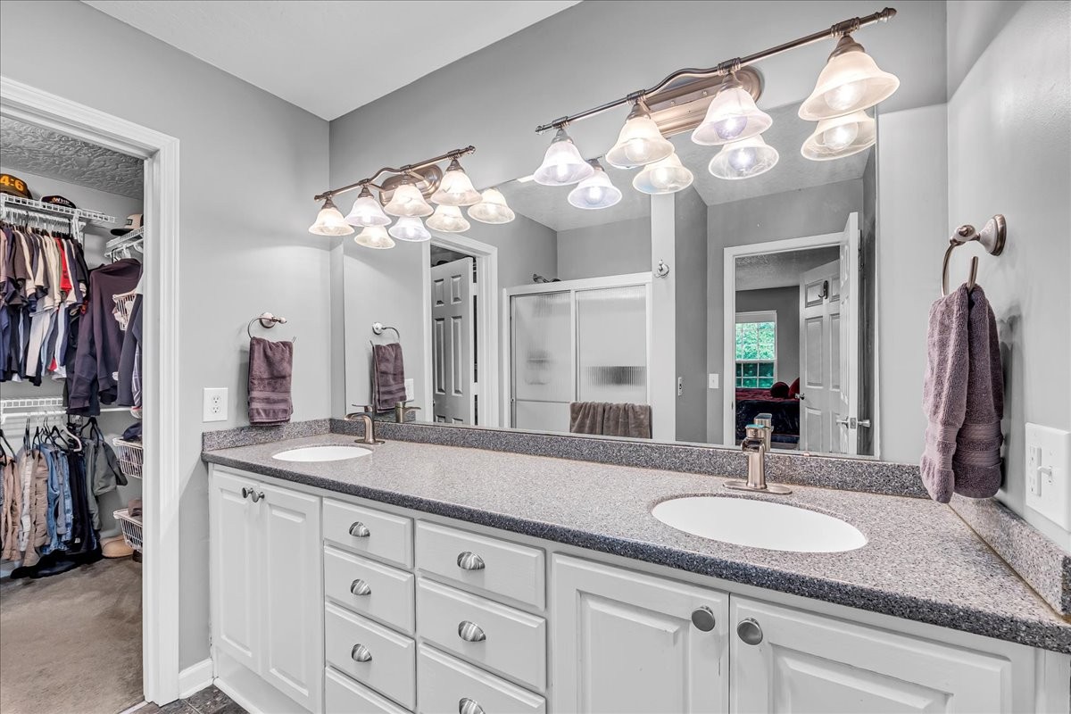 3955 River Road Baxter, TN 38544 - Photo 29 of 78 a bathroom with a sink double vanity granite and a mirror