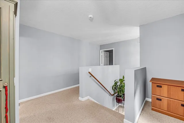 a bedroom with furniture and a chandelier fan