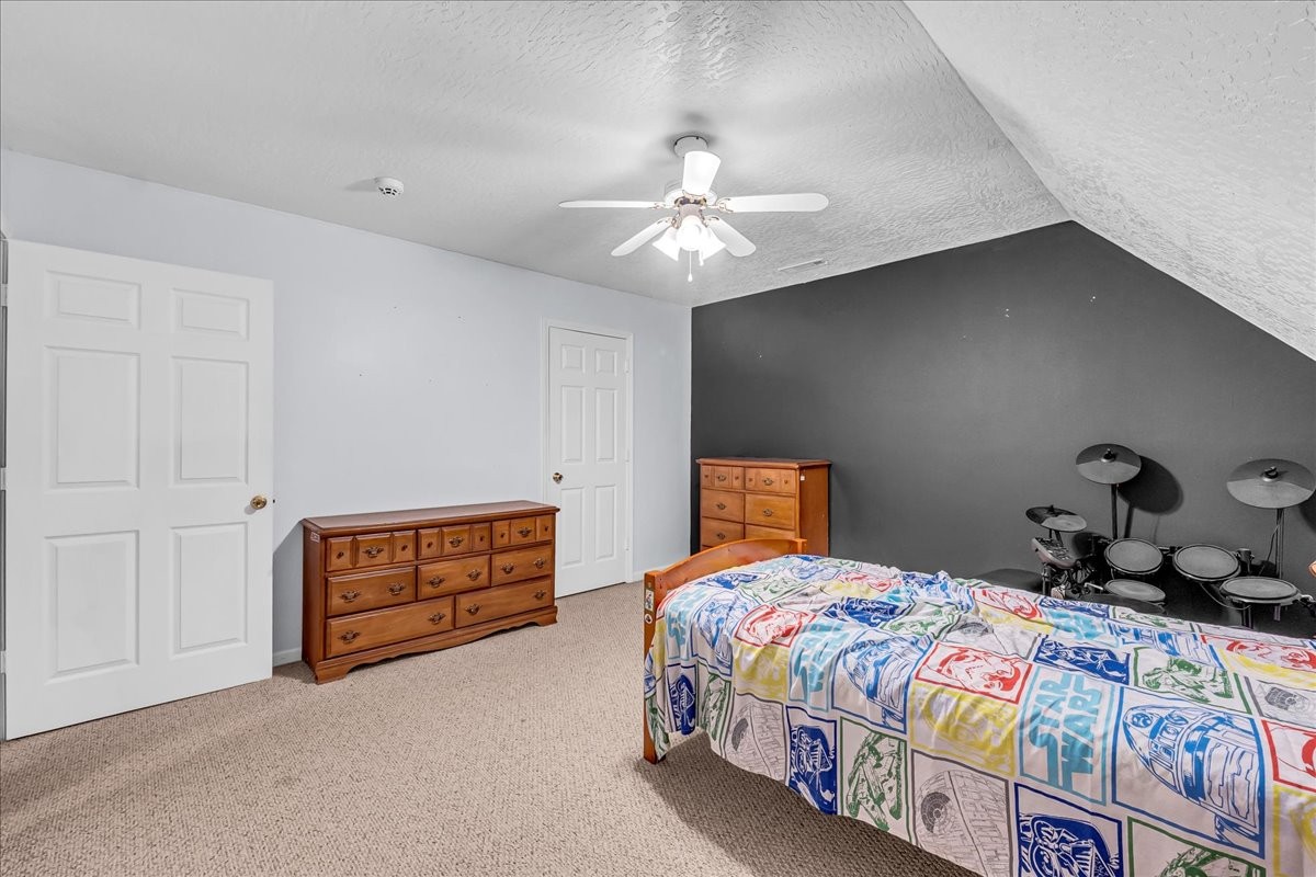 3955 River Road Baxter, TN 38544 - Photo 38 of 78 a bedroom with a bed and a chandelier