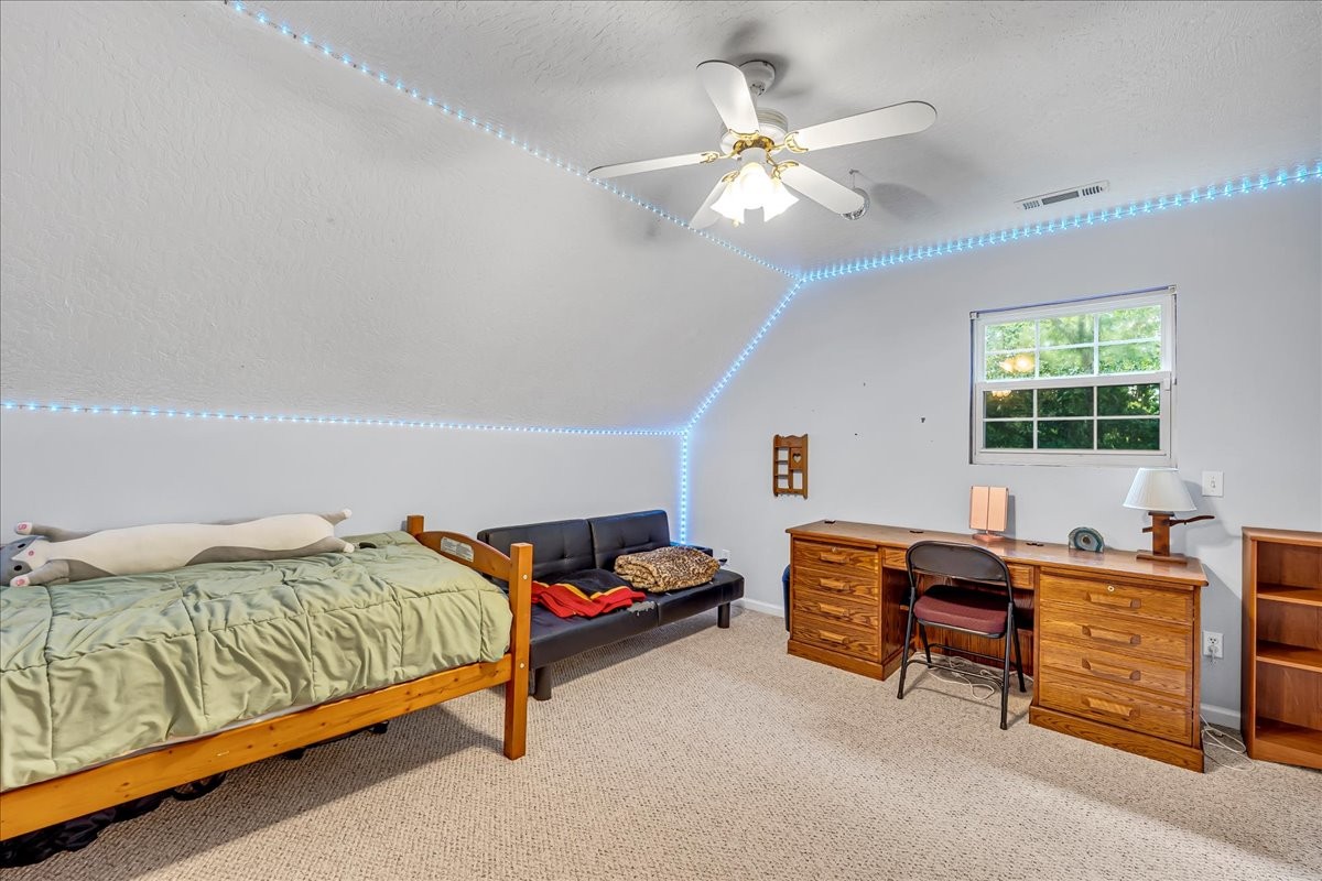 3955 River Road Baxter, TN 38544 - Photo 39 of 78 a bedroom with a bed and a chandelier