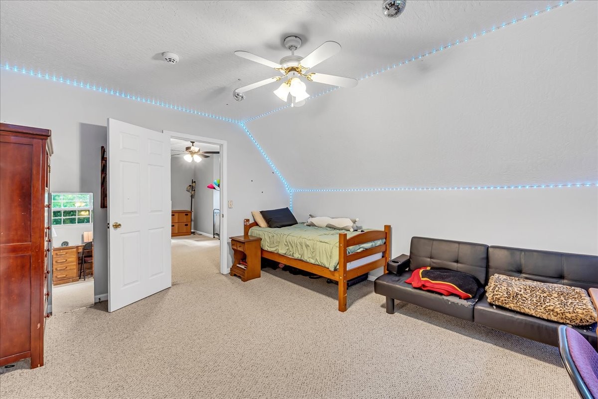 3955 River Road Baxter, TN 38544 - Photo 40 of 78 a bedroom with furniture and a chandelier fan