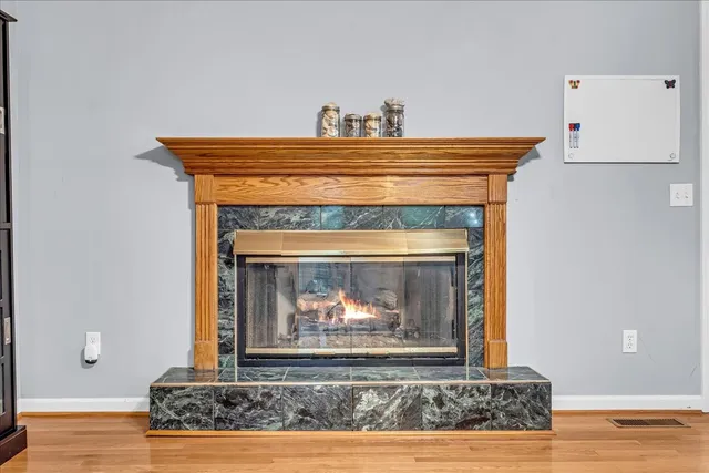 a view of an empty room with a fireplace and a window