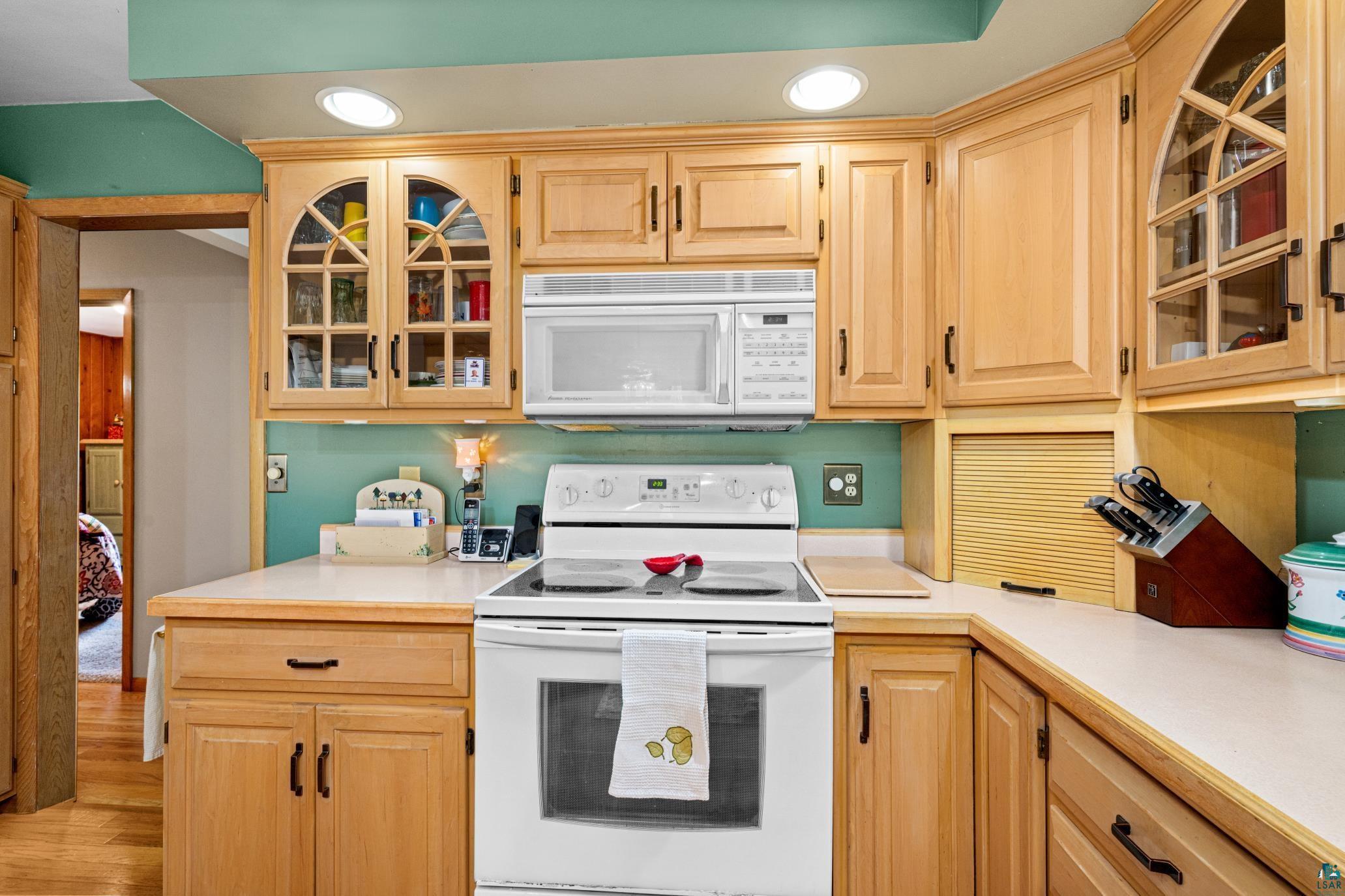 3727 Stebner Road Hermantown, MN 55811 - Photo 12 of 41 Kitchen featuring wood cabinetry, white countertops, built-in microwave, electric range, and recessed lighting