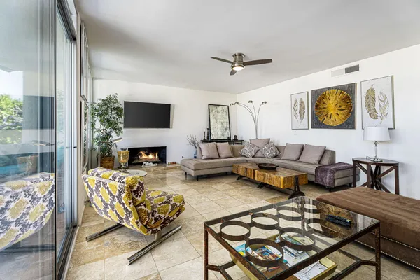 a living room with furniture a fireplace and a flat screen tv