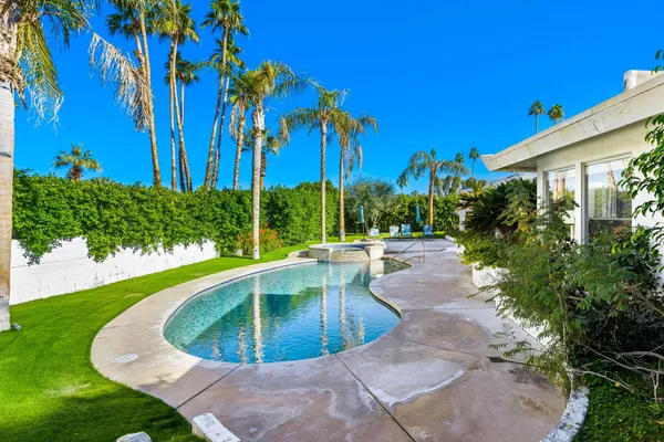 a view of a swimming pool with a patio