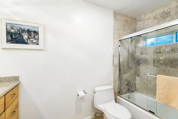 a bathroom with a toilet and a shower