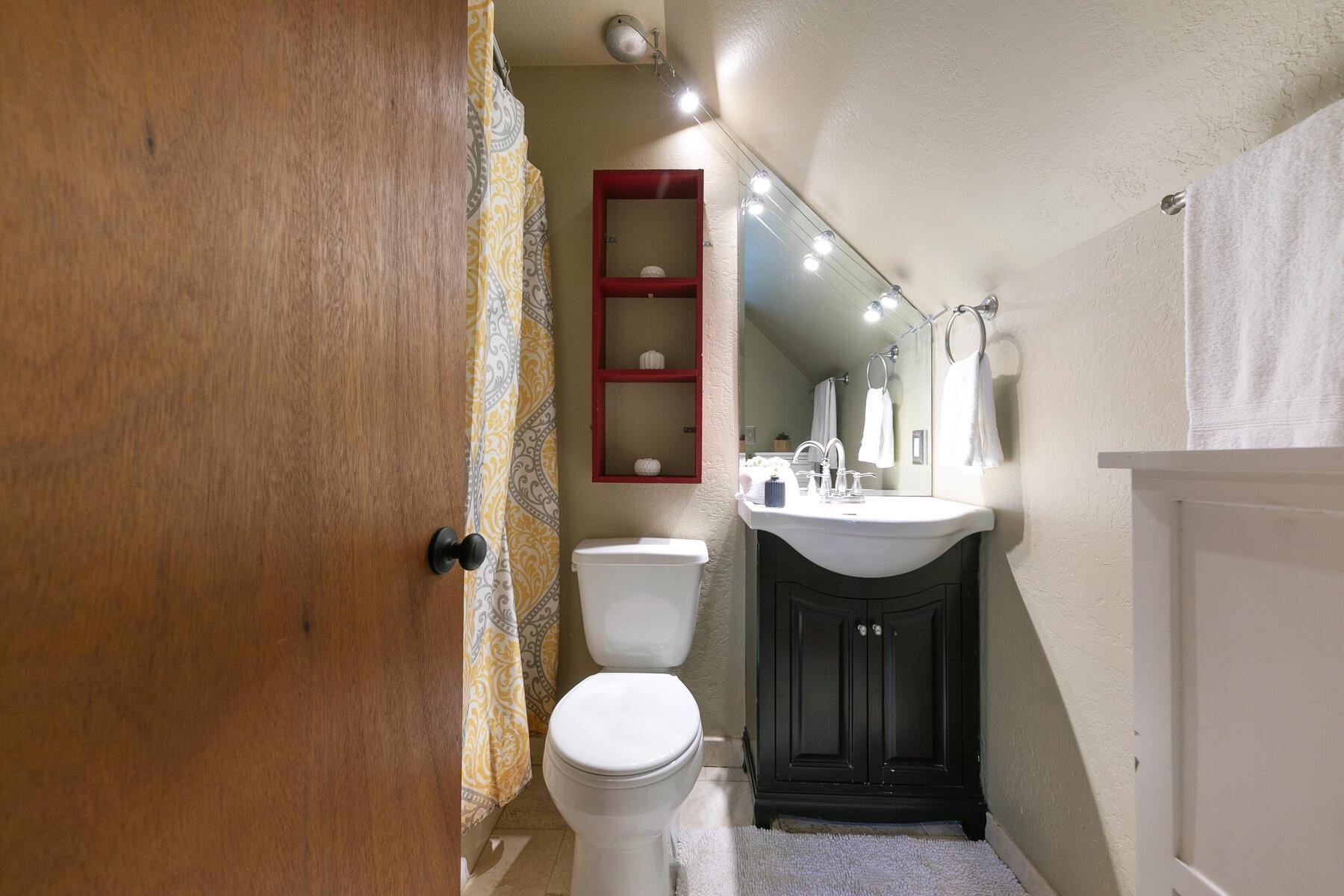10243 Laburnham Circle Truckee, CA 96161 - Photo 14 of 21 a bathroom with a sink toilet a mirror and vanity