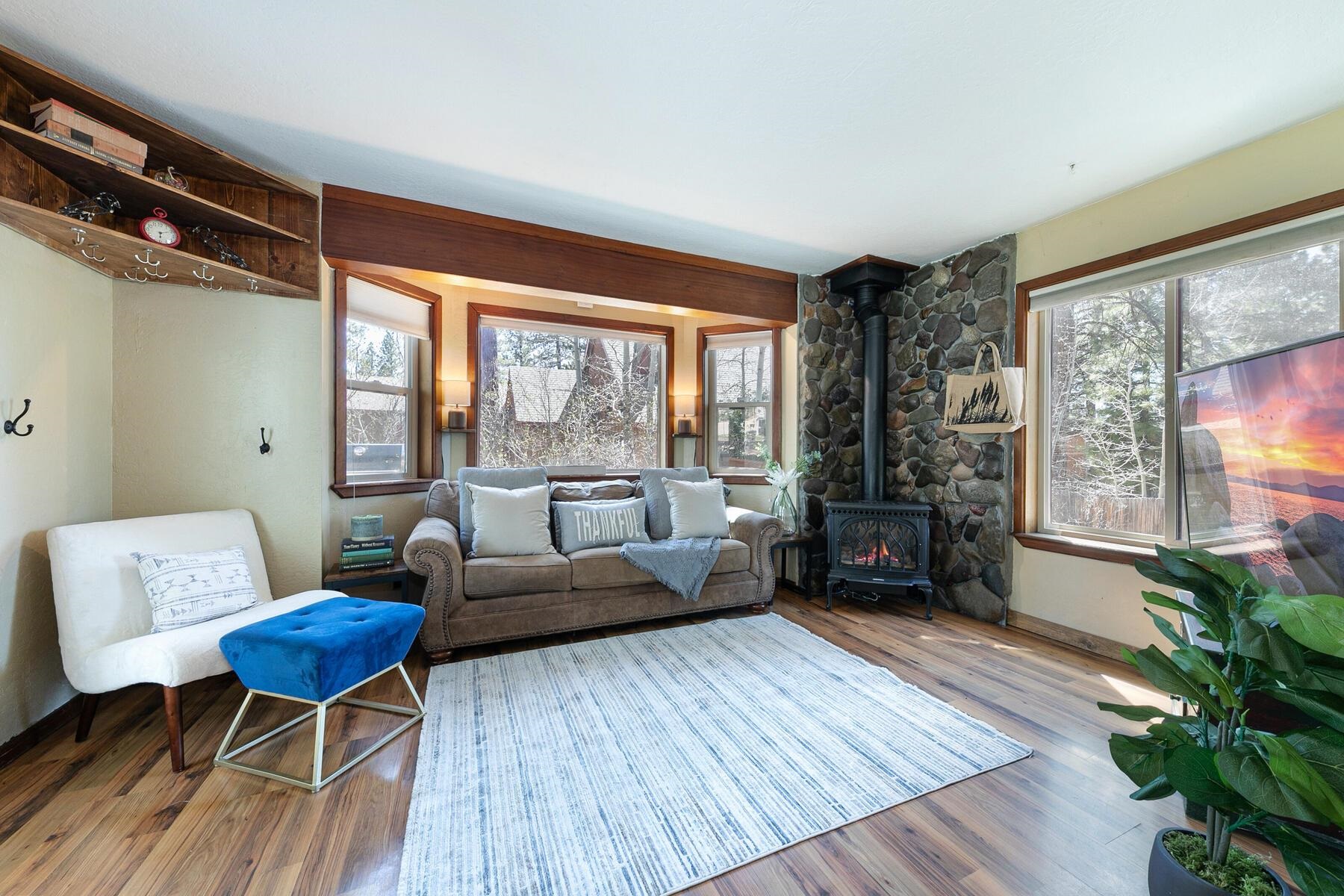 10243 Laburnham Circle Truckee, CA 96161 - Photo 3 of 21 a living room with furniture a large window and wooden floor