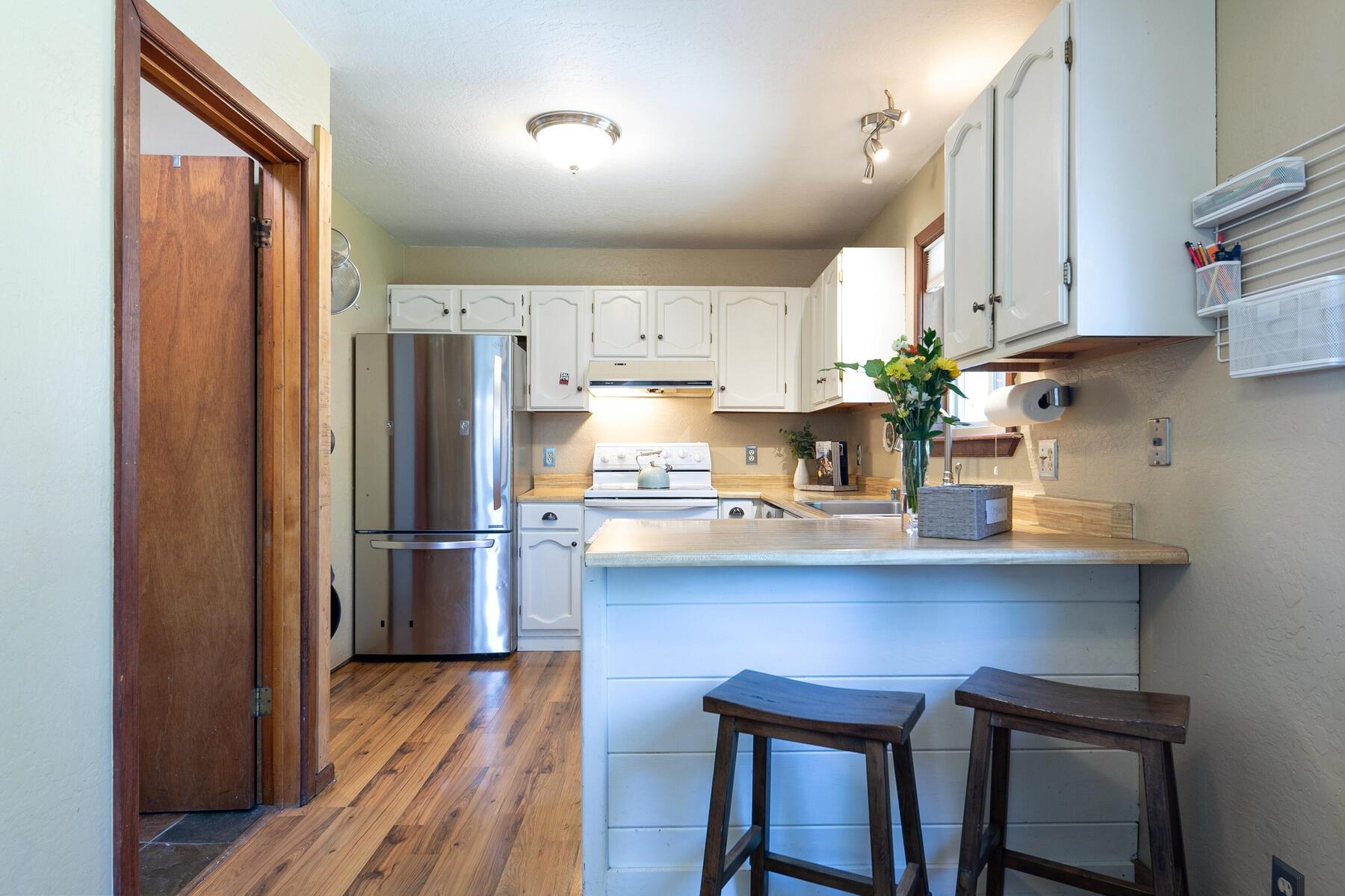 10243 Laburnham Circle Truckee, CA 96161 - Photo 8 of 21 a kitchen with stainless steel appliances a dining table chairs refrigerator and cabinets