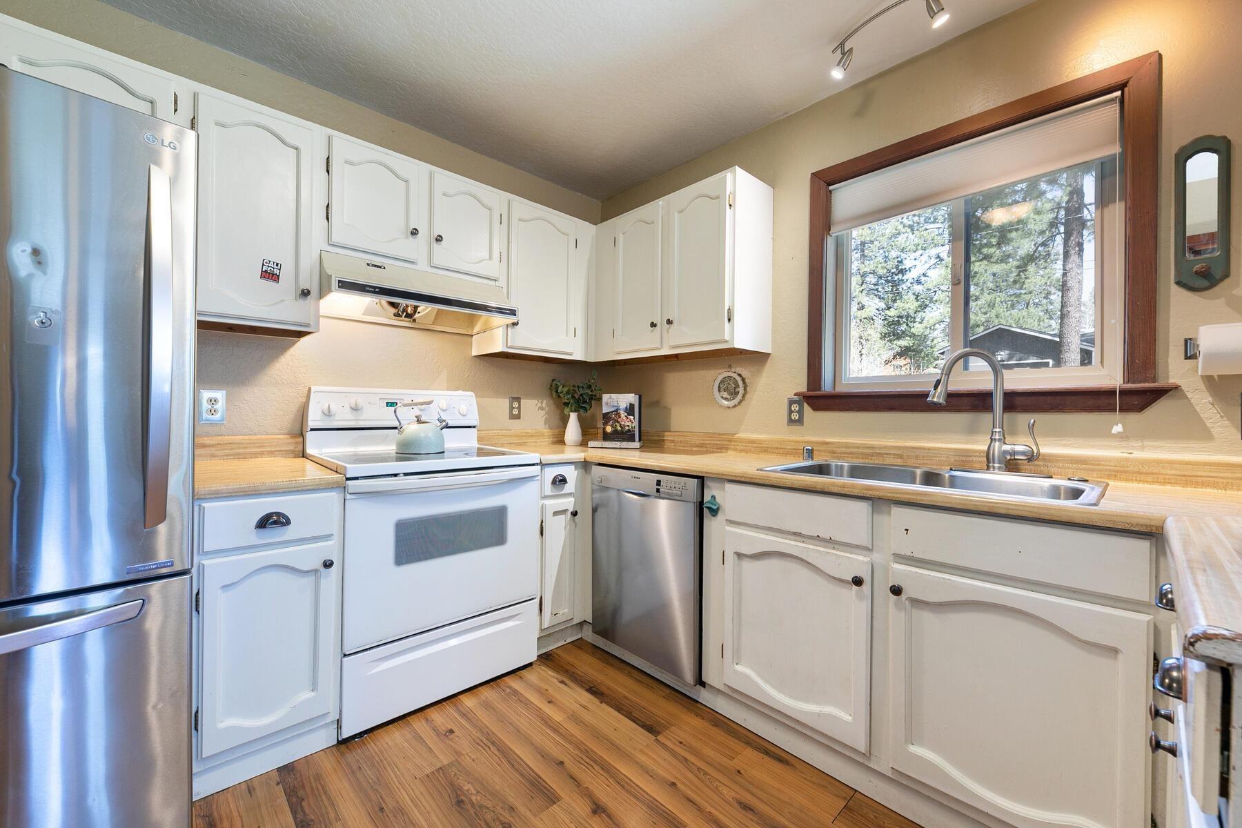 10243 Laburnham Circle Truckee, CA 96161 - Photo 10 of 21 a kitchen with white cabinets and white appliances
