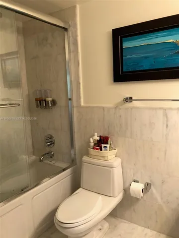 a bathroom with a toilet a sink and bathtub