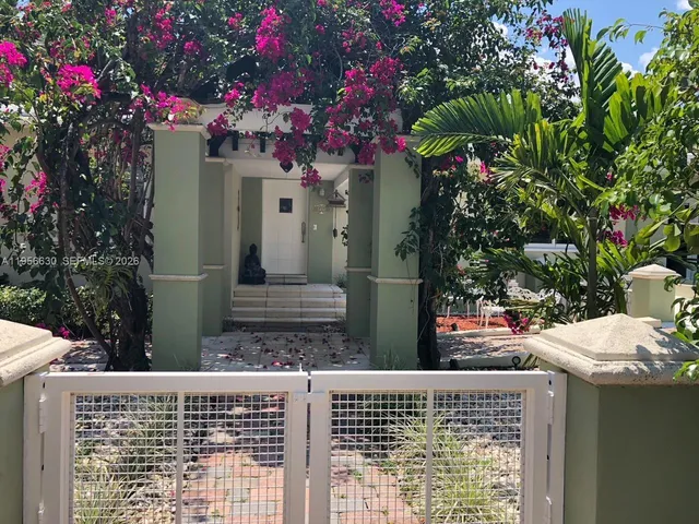 a couple of cars parked in front of a house