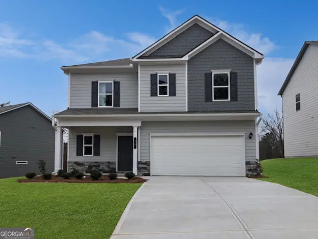a front view of house with yard and green space