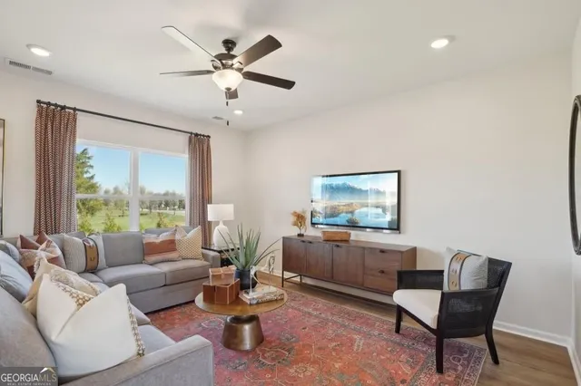 a living room with furniture and a large window