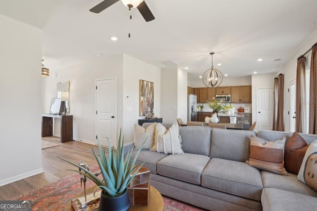 11 North Haven Drive Rome, GA 30165 - Photo 8 of 35 a living room with furniture a chandelier and a dining room