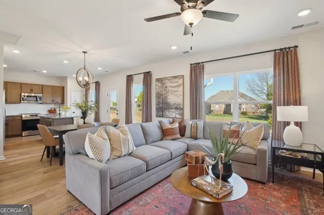 a living room with furniture and a large window