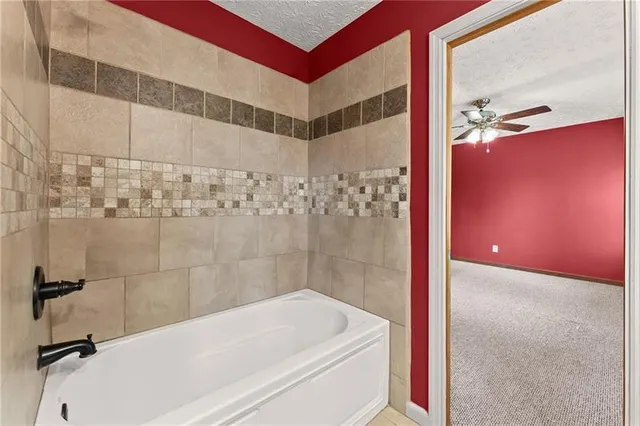 an empty room with chandelier fan