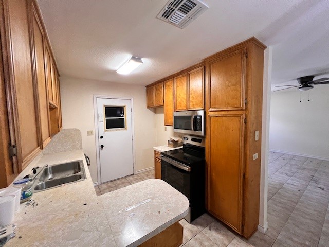 1200 Kline Avenue, Unit B Odem, TX 78370 - Photo 6 of 10 a kitchen with a refrigerator and a sink