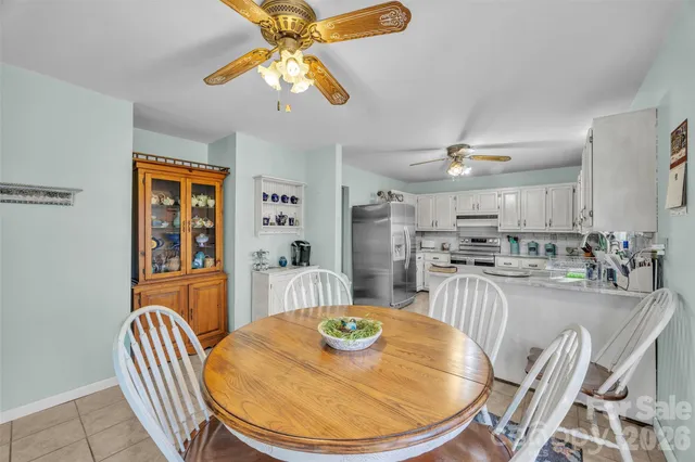 a kitchen with stainless steel appliances granite countertop a sink dishwasher and cabinets with wooden floor