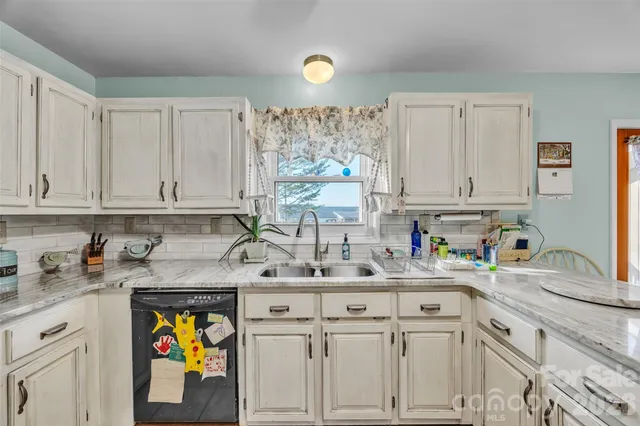 a spacious bedroom with a bed and a chandelier