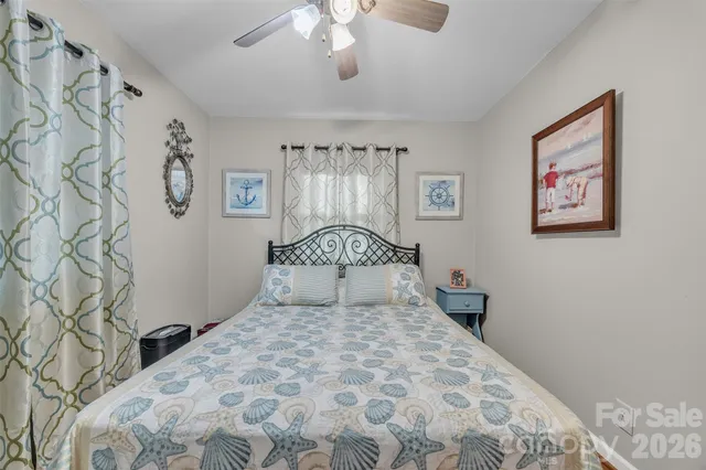 a bedroom with a bed and a chair