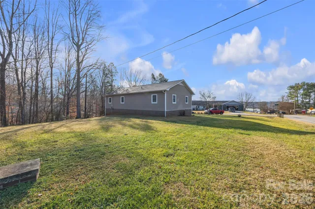 a view of a wooden balcony and trees