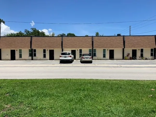 a view of house with outdoor space and parking