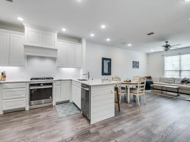 a kitchen with stove a sink and a refrigerator