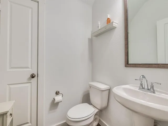 a white toilet sitting next to a bathroom sink