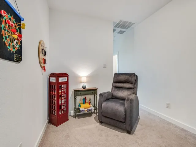 a hallway with a couch and a painting on the wall