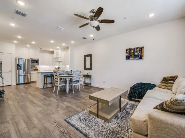 a living room with furniture and kitchen view