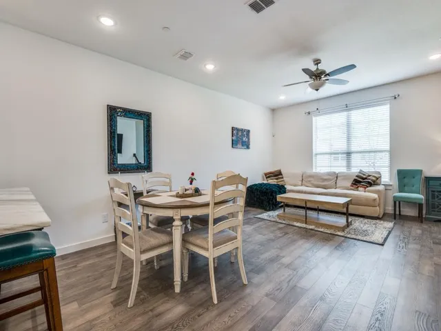 a living room with furniture a wooden floor and a window