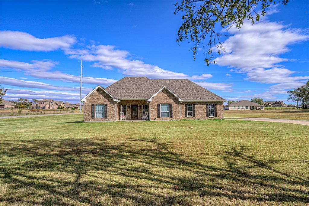 10264 Farmington Road Van Alstyne, TX 75495 - Photo 3 of 39 a front view of a house with a garden